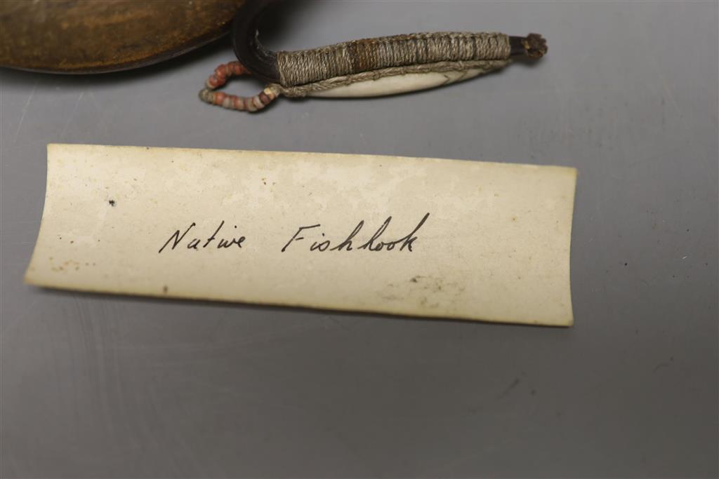 A rare 19th century Eskimo-Aleut nephrite and wood mouthpiece for a bow drill, 9cm and a carved walrus ivory fish lure, 6.2cm,
